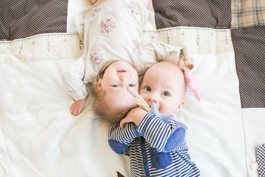 Babies with Soft textile baby rattle and grabbing toy made from upcycled cotton