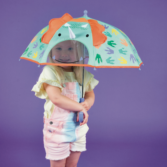 Holding up Floss and Rock Color Changing 3D Umbrella - Dinosaur for kids, featuring magic color-changing technology and 3D dinosaur features."