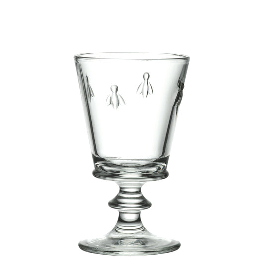 A detailed photograph of a single 220ml La Rochere Bee glass with its iconic embossed bee pattern, set against a simple, neutral background.