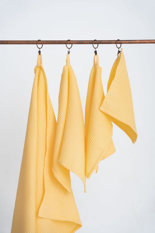 Yellow Organic Waffle Cotton Towel Set Hanging - Medium Distance View | NUSS