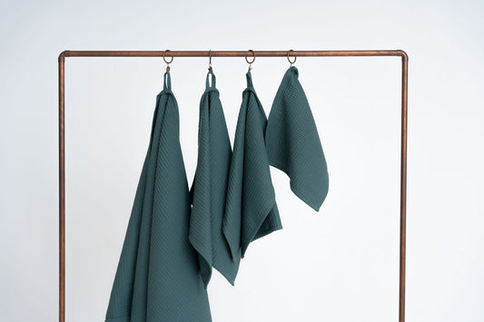Petrol Blue Organic Waffle Cotton Towels Hanging - Medium Distance View | NUSS