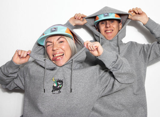 Male and Female wearing Premium Unisex Heavy Cotton Hoodie Stinky - Grey on a clean background