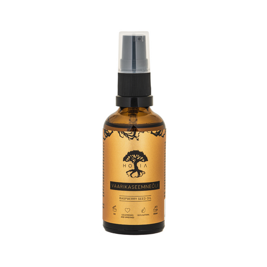 A spray bottle of HOIA Raspberry Seed Oil with a dark label and a tree illustration, indicating it's a skin care product.