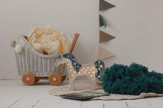 Cosy playroom scene: Cream, Grey and Teal flags on a white wall