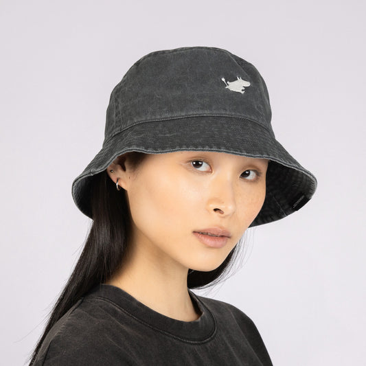 Half-body portrait of a woman wearing the black washed denim Moomin bucket hat by Nordicbuddies