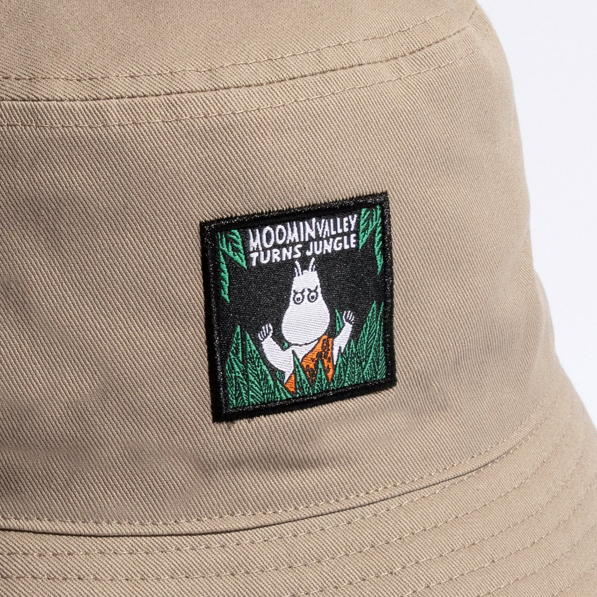 Close-up shot showing the beige cotton fabric texture and detailed Moomin Jungle graphic print by Nordicbuddies