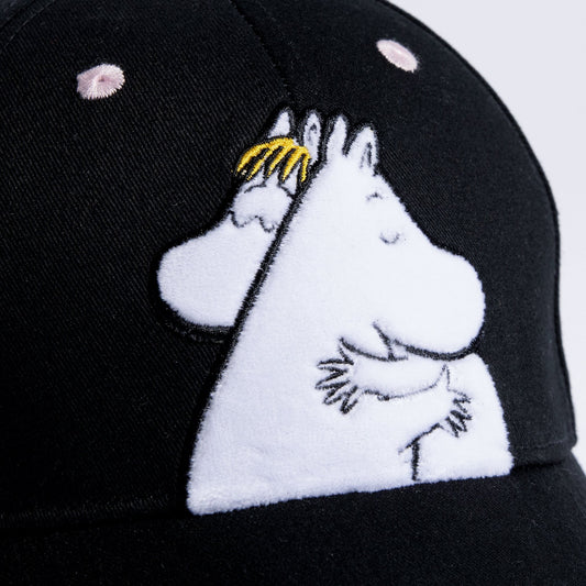 Close-up shot showing the soft cotton twill fabric texture and embroidered Moomin Love artwork on the kids cap by Nordicbuddies
