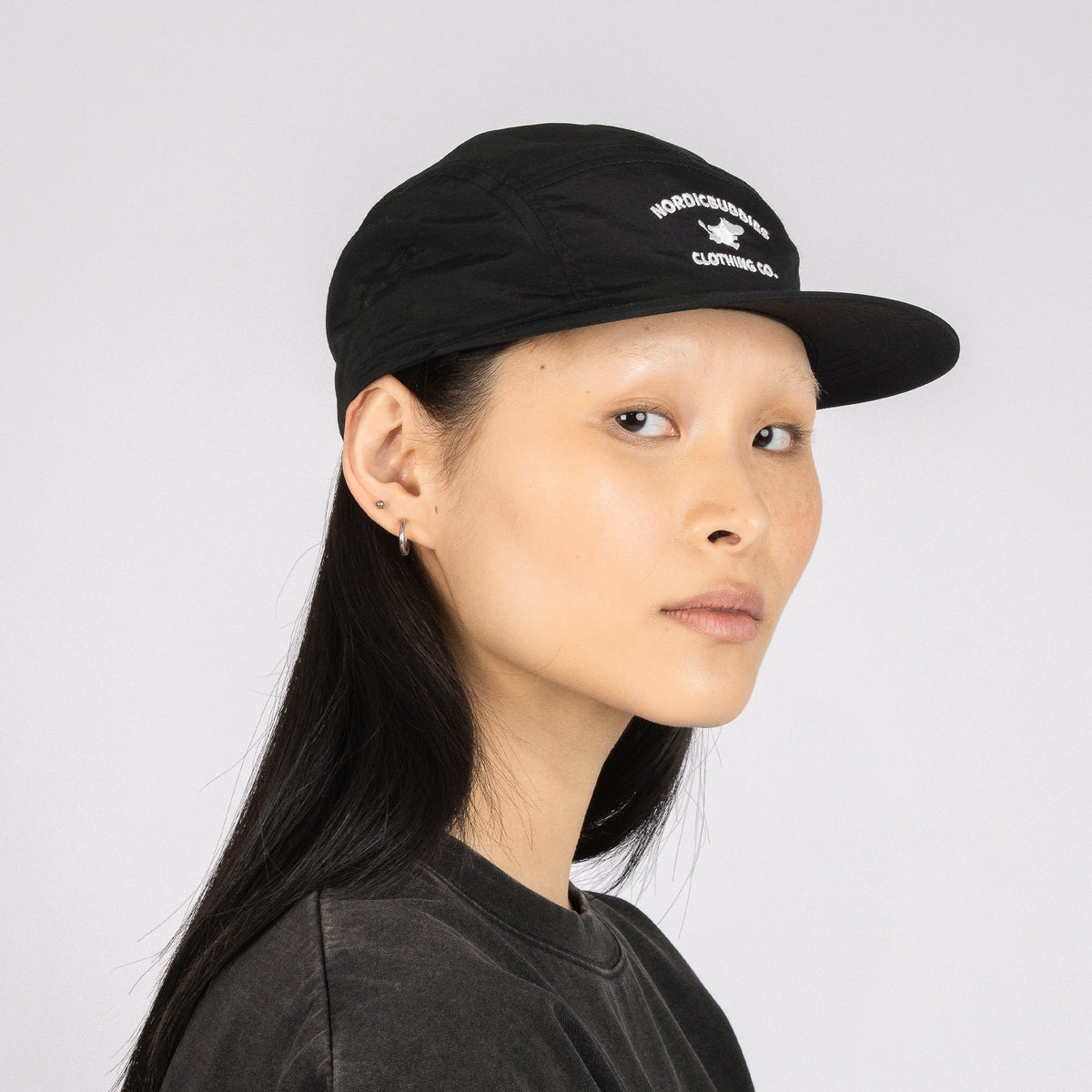Female Model wearing the Moomintroll Adventure Nylon 5-panel Cap in black