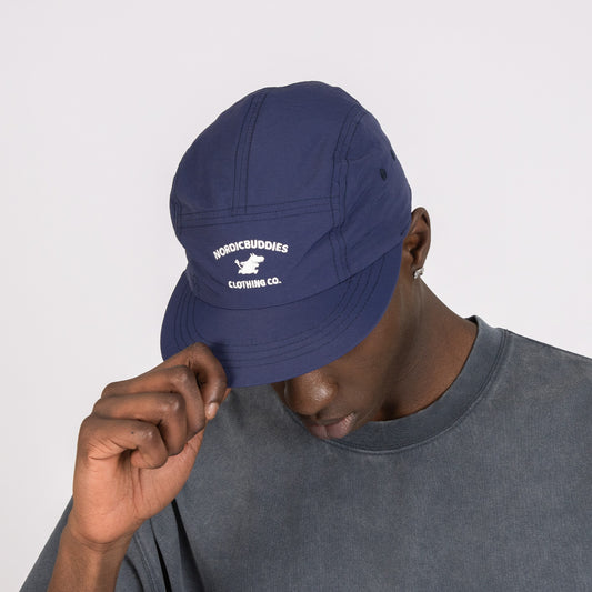 Male model wearing the Moomintroll Adventure Nylon 5-panel Cap in navy