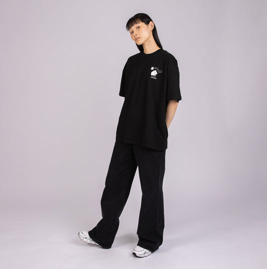 Person wearing a black outfit with a logo on a plain background