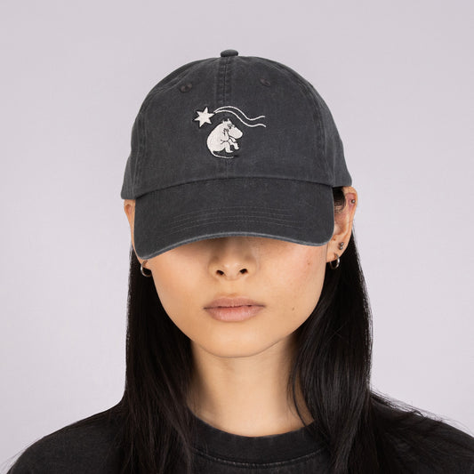 Female model wearing the black Moomin Novels washed denim cap in streetwear style - front view