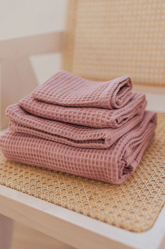 4-Piece Old Pink Organic Waffle Cotton Towel Set Folded on Chair | NUSS
