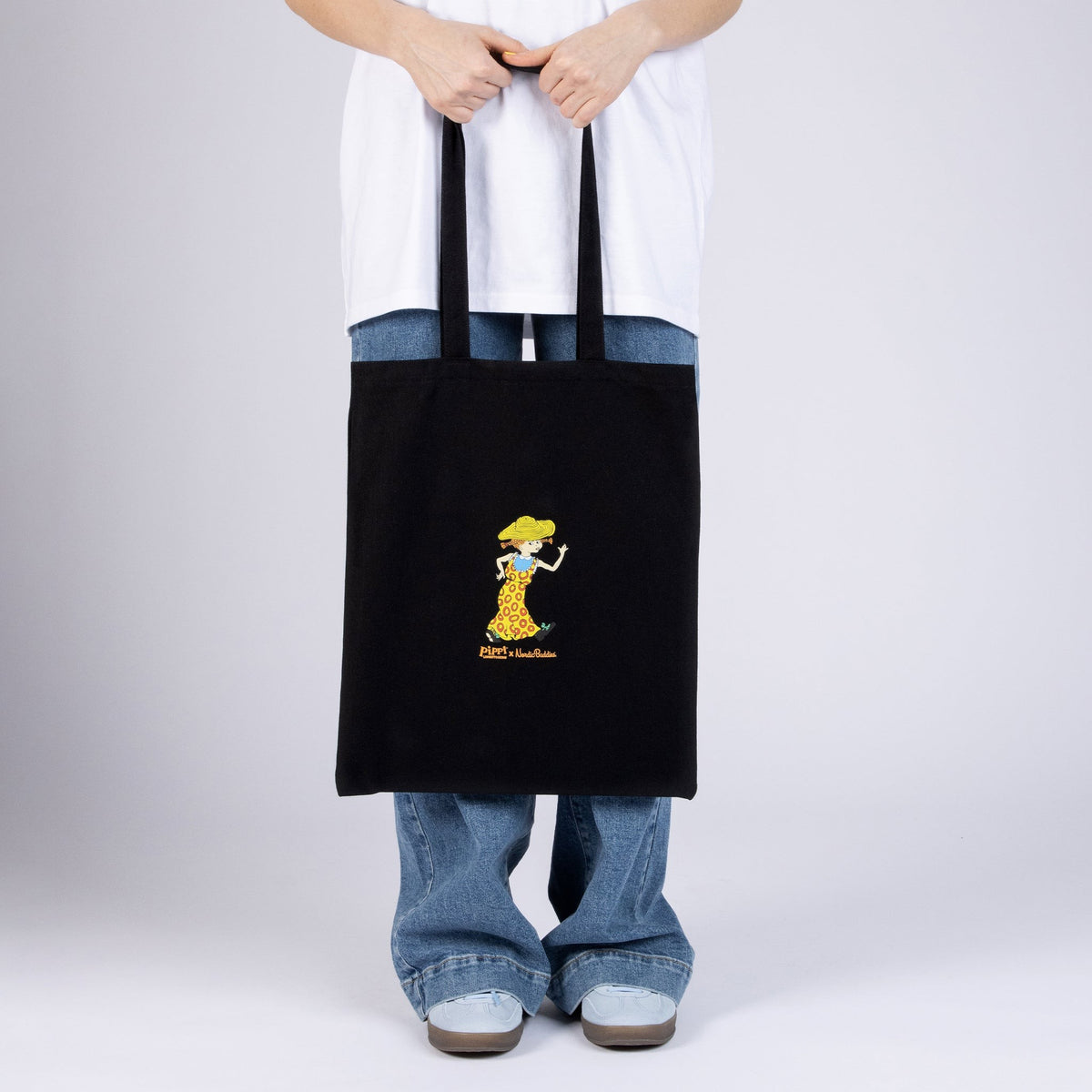 Model wearing black Pippi Longstocking tiger cotton tote bag back view