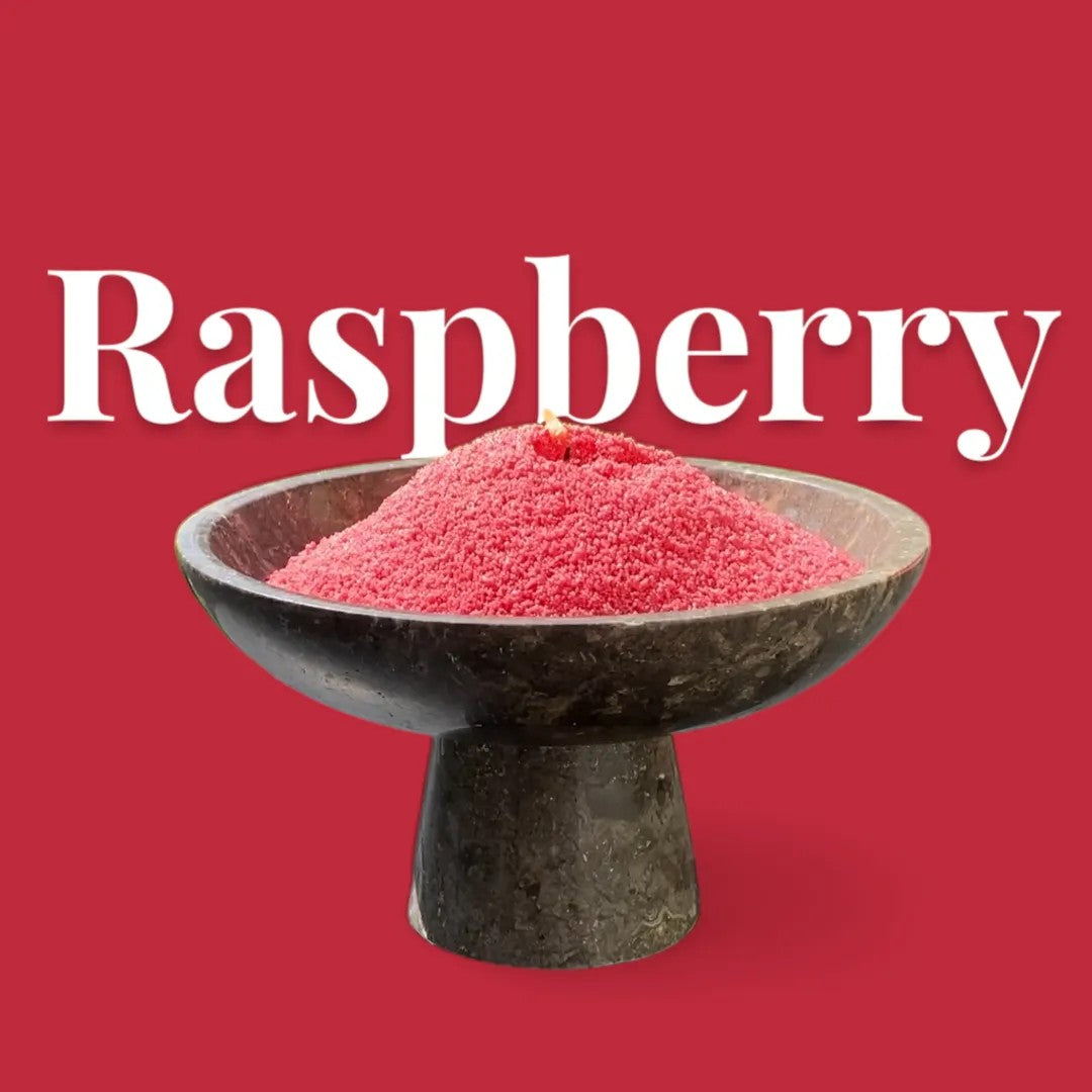 Raspberry text on a matching rich raspberry red background with a glass vase full of unlit pearled candle sand in the foreground