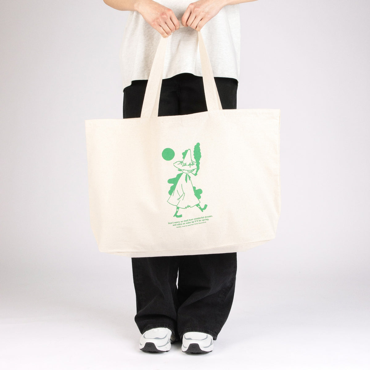 Different view of Model carrying the oversized Moomin Snufkin XXL tote bag on a clean background