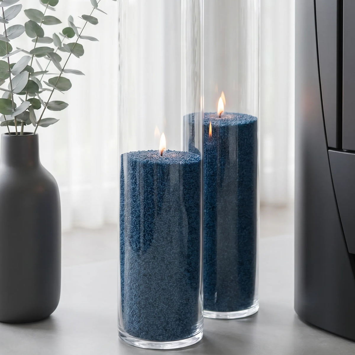 Modern home interior styling featuring an lit Space Grey pearled sand candles