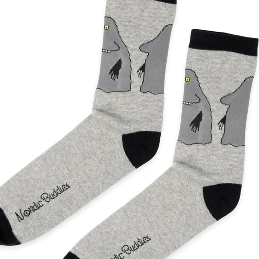 Close-up of woven The Groke character artwork and fine knit cotton texture on men's socks