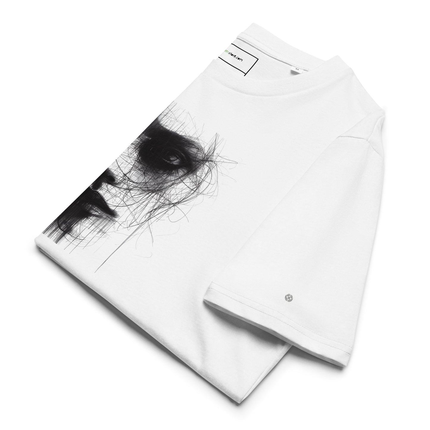 Neatly folded That Green Store 'Soliloquy' white t-shirt. The charcoal graphic face and red text are visible on the top fold, highlighting the organic cotton texture.