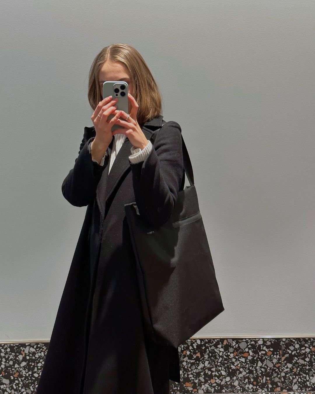 Model posing with compact VIK Small Tote Bag, minimalist vegan felt handbag