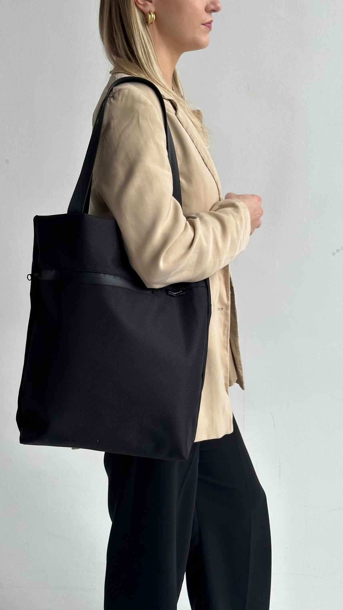 Model holding VIK Small Tote Bag in recycled felt, minimalist sustainable accessory