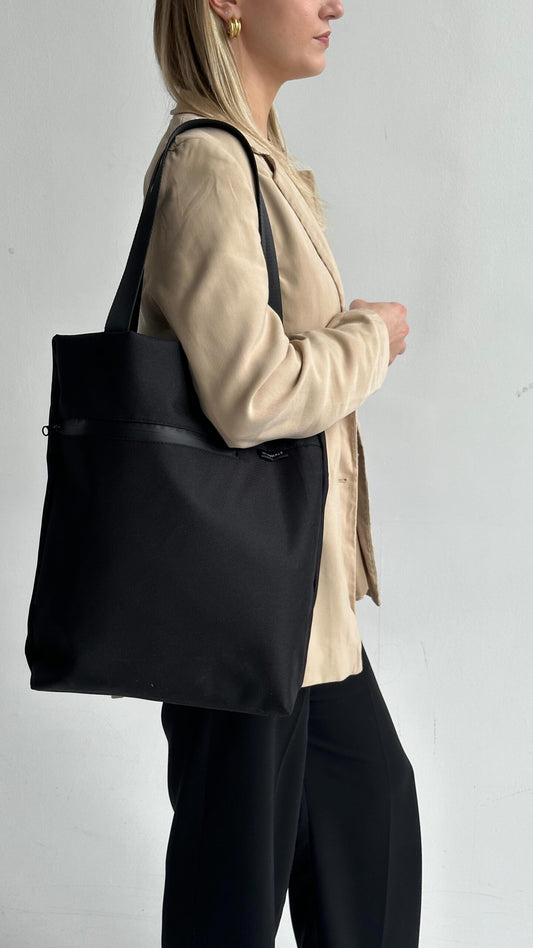 Model holding VIK Small Tote Bag in recycled felt, minimalist sustainable accessory