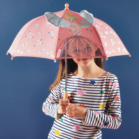 Holding up Floss and Rock Color Changing Umbrella - Enchanted, showing magical forest illustrations that change color when wet."