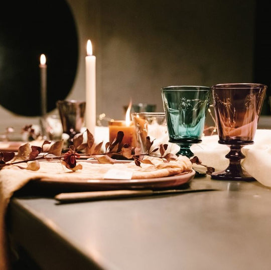 Romantic candlelight table setting featuring glowing colorful La Rochere Bee Glasses 220ml