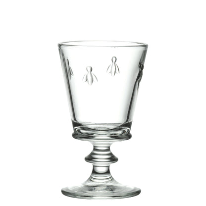 A detailed photograph of a single 220ml La Rochere Bee glass with its iconic embossed bee pattern, set against a simple, neutral background.