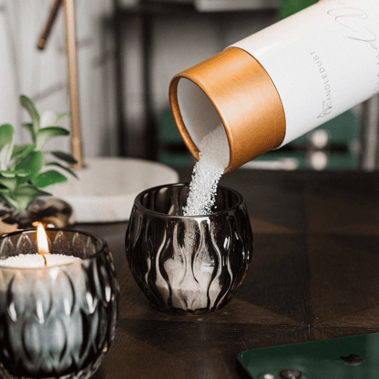 Lifestyle: lit Breeze scented powdered candle in a large container