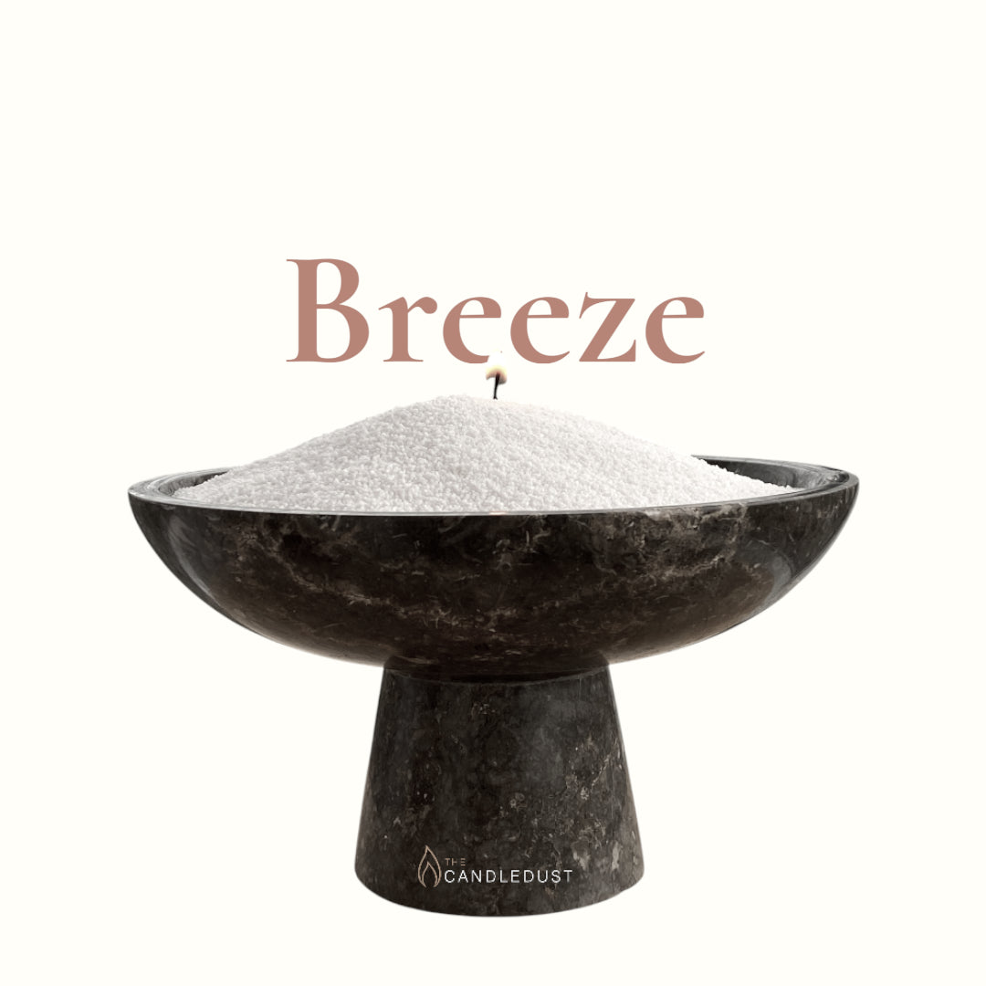 Breeze text on a matching fresh background with a glass vase full of unlit pearled candle sand in the foreground