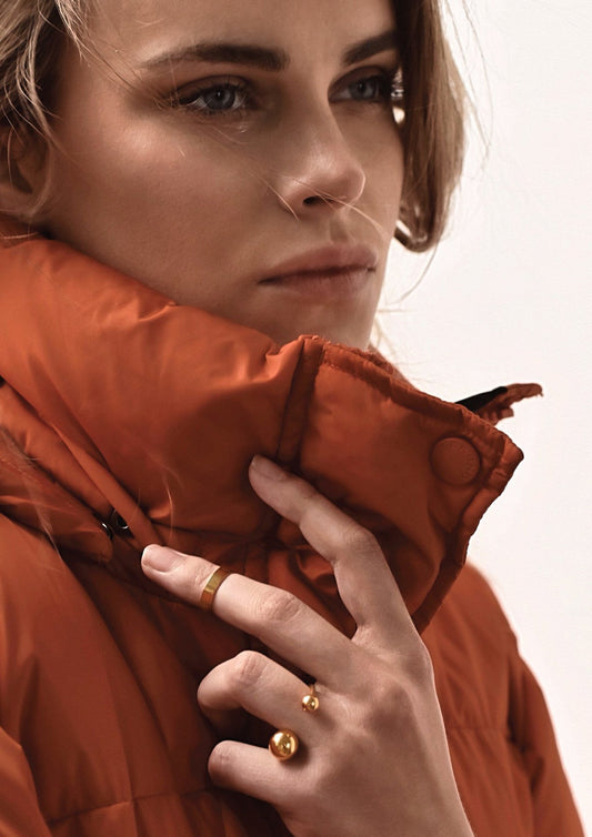 Woman's hand perfectly showcasing the gold Big Bomb Multisize Ring on her finger.