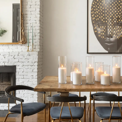 Glass vases of various heights filled with burning Diamond Dust pearled candle sand creating a glowing cluster