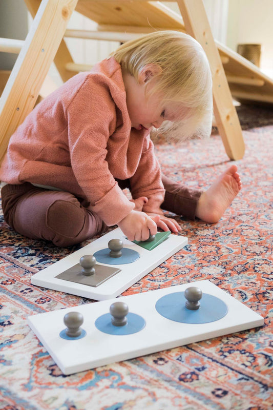 Kid playing with Karloova Solid Montessori Wood Shape Puzzle - Circles in Various Sizes