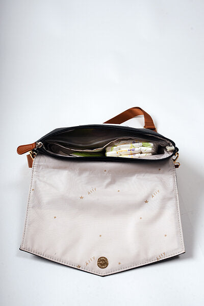 Internal View Modern mother wearing the Black Coffee handbag as a stylish crossbody bag
