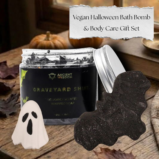 Vegan Halloween Bath Bomb and Body Care Gift Set featuring a black bat bath bomb, a white ghost bath bomb, and Graveyard Shift whipped soap on a rustic autumn table