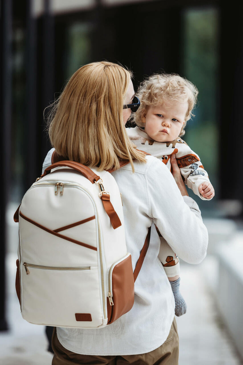 Parent walking outdoors with the Large Cappuccino Backpack for a weekend trip