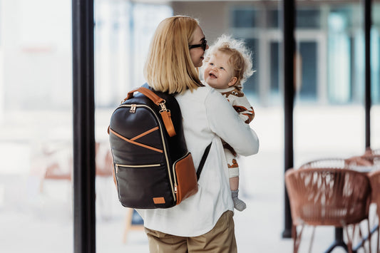 Travel with baby - Large Black Coffee backpack in a transit setting
