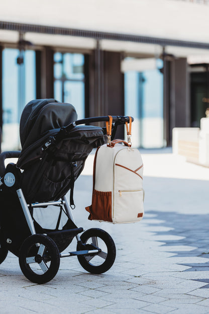 Large Diaper Backpack in Cappuccino hanging securely on a stroller handle for hands-free convenience