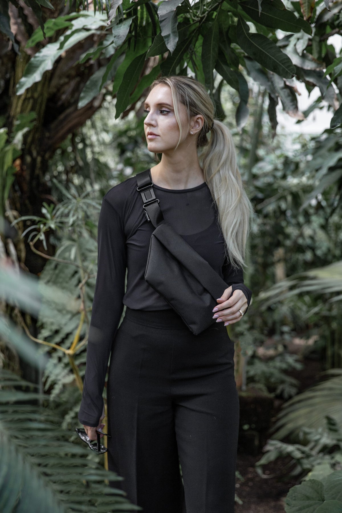 Model wearing OSLO Crossbody Bag in recycled felt, minimalist eco-friendly style