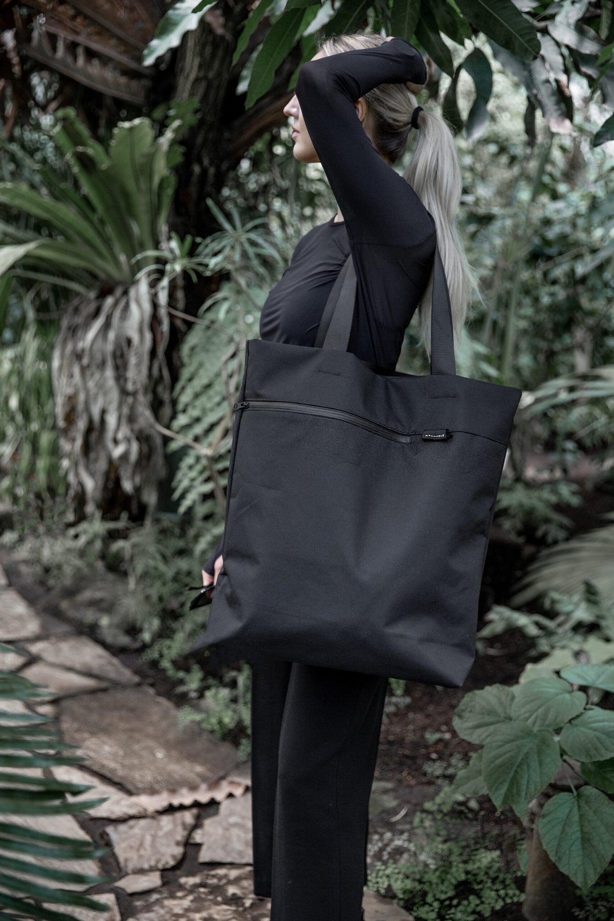 Female model carring VIK Large Tote Bag in recycled felt, spacious eco-friendly shoulder bag - outdoor view