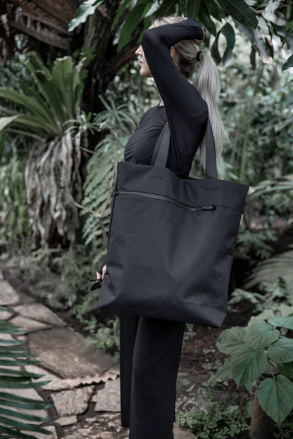 Female model carring VIK Large Tote Bag in recycled felt, spacious eco-friendly shoulder bag - outdoor view