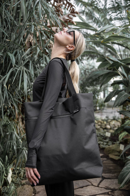 Model carrying VIK Large Tote Bag outdoors during walking, spacious recycled felt laptop bag