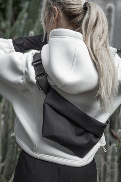 Female model wearing OSLO Crossbody Bag front view in charcoal gray recycled felt, sustainable vegan bag - back view