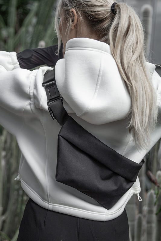 Female model wearing OSLO Crossbody Bag front view in charcoal gray recycled felt, sustainable vegan bag - back view