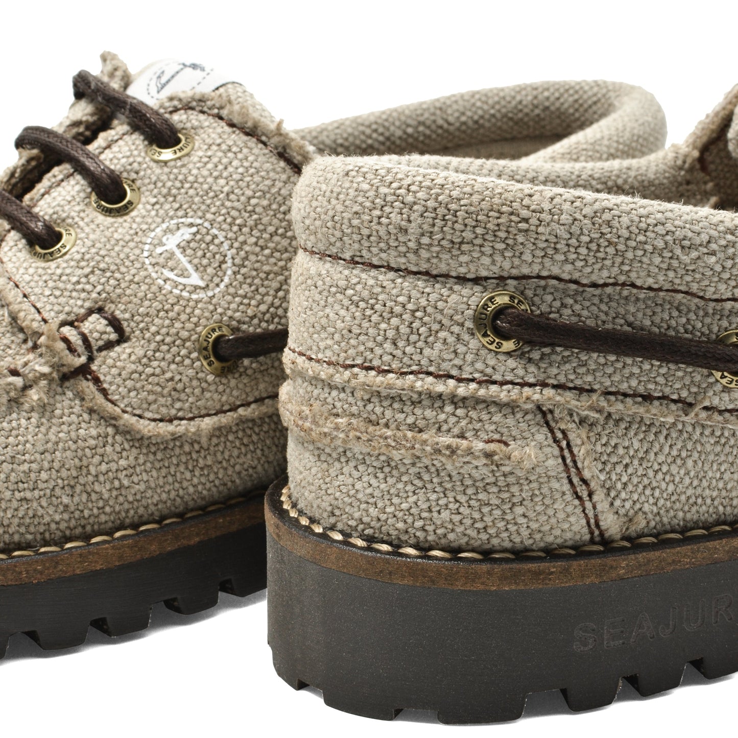 Close-up heel detail of Seajure Embleton showing logo emblem and organic hemp fabric texture