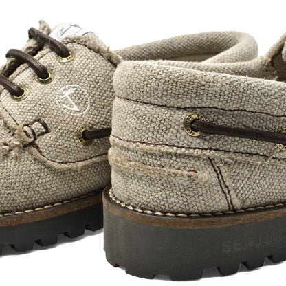 Close-up heel detail of Seajure Embleton showing logo emblem and organic hemp fabric texture
