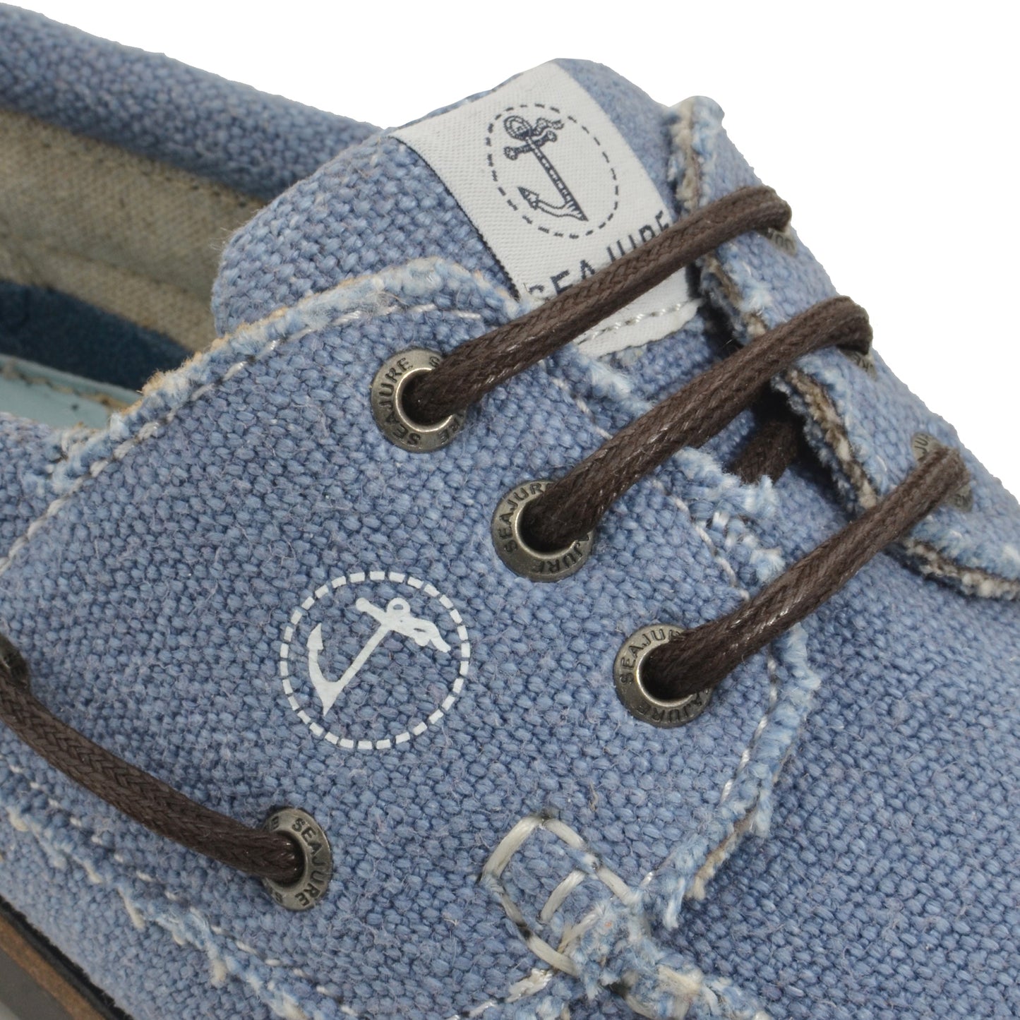 Close-up of detail of Seajure Pampelonne showing logo emblem and organic hemp fabric texture
