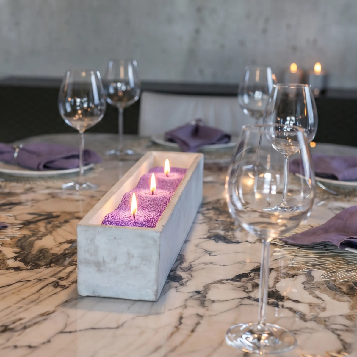 Elegant marble table featuring a center marble tray filled with burning Amethyst pearled sand candles