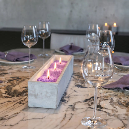 Elegant marble table featuring a center marble tray filled with burning Amethyst pearled sand candles