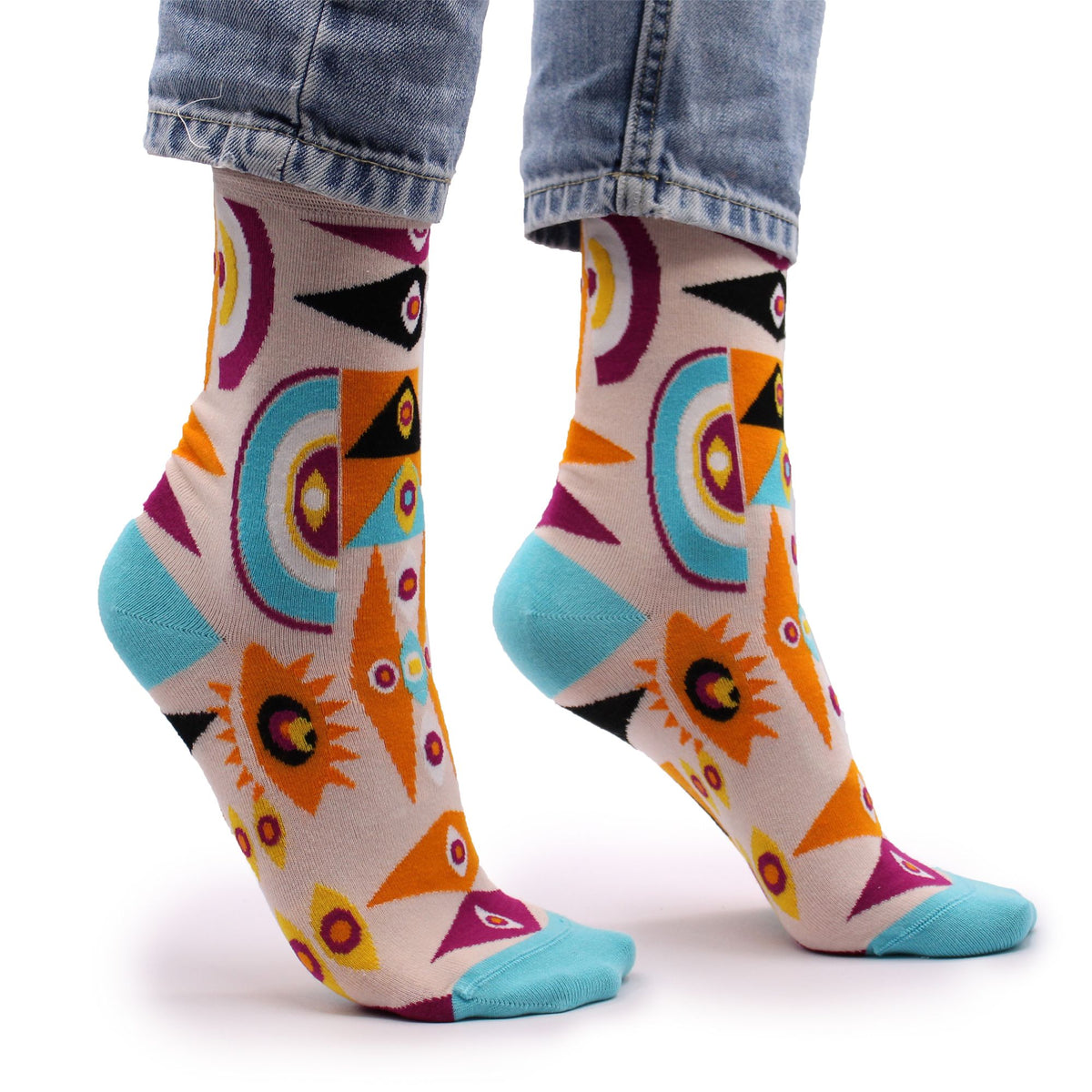 Side view of Hop Hare Psychedelic Evil Eye bamboo socks worn barefoot, showcasing the vibrant protective eye motif on the ankle